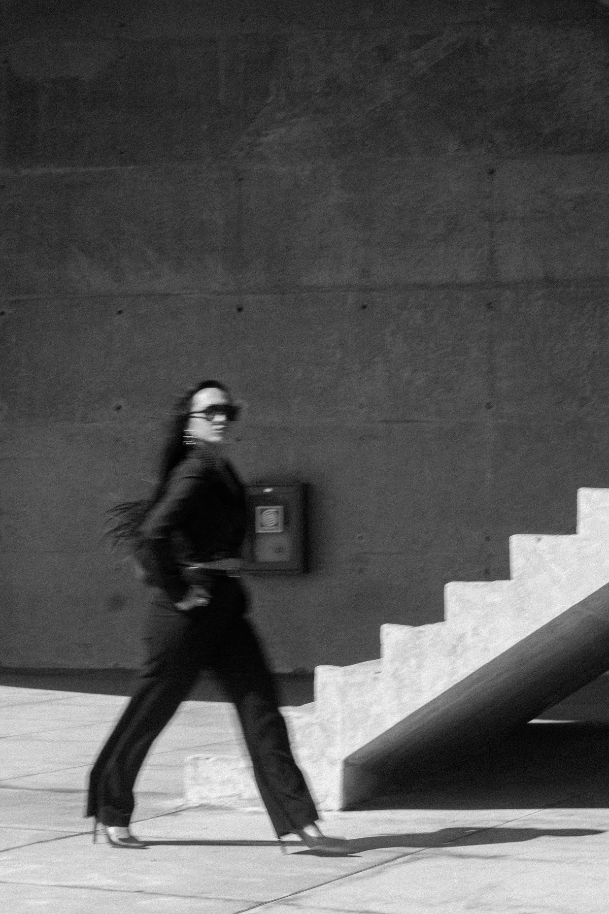 Carol caminhando em uma fotografia editorial em preto e branco